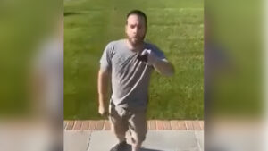 An off-duty NYPD officer identified as Douglas Debonet was seen on video pulling a gun on his neighbor during an argument following an alleged road rage incident in Seldon. (Credit: Screenshot/YouTube)