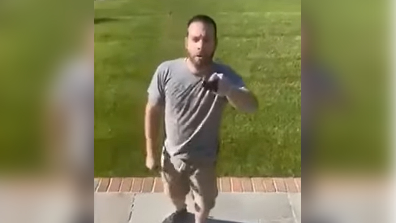 An off-duty NYPD officer was seen on video pulling a gun on his neighbor during an argument following an alleged road rage incident in Seldon. (Credit: Screenshot/YouTube)