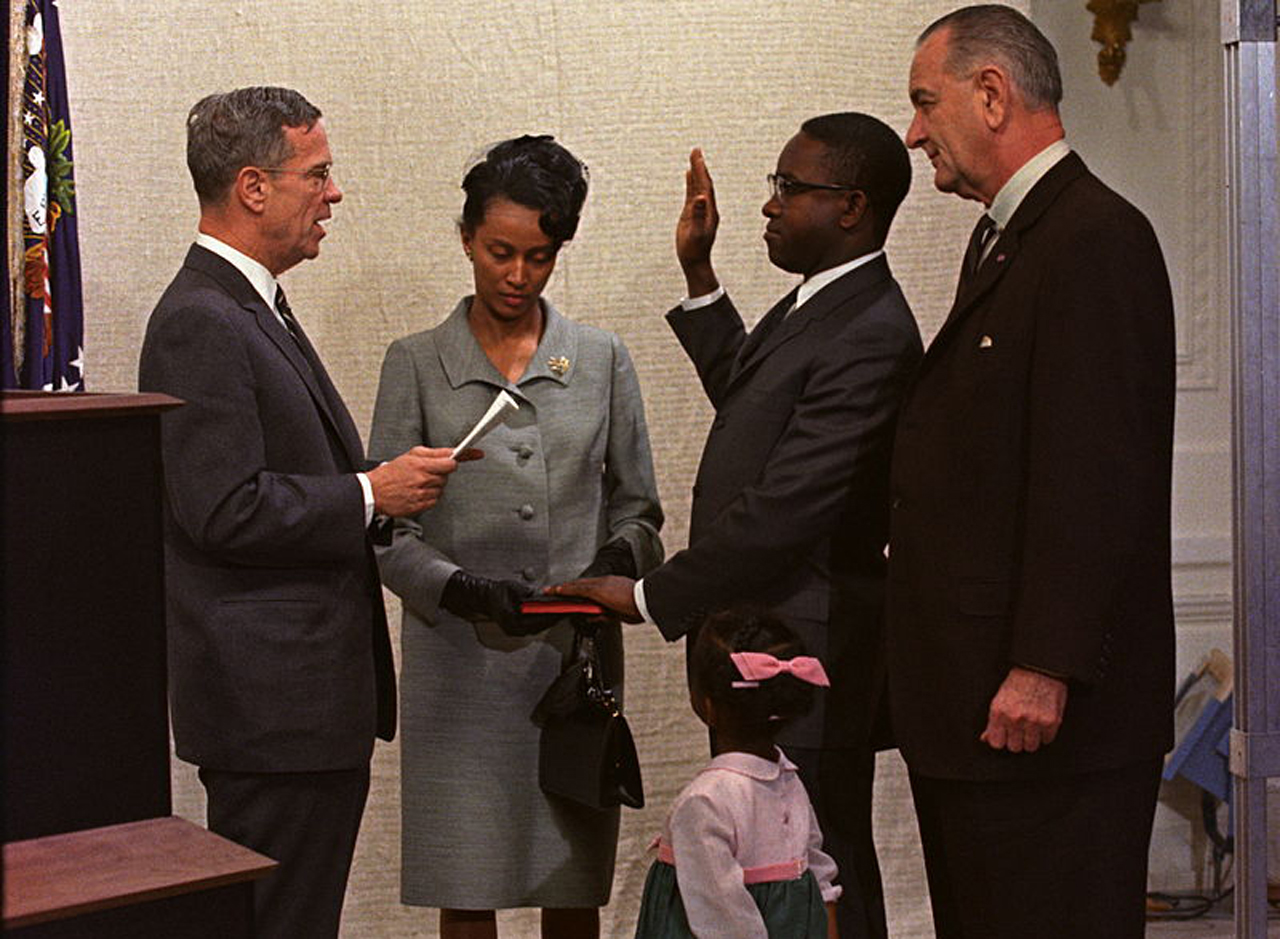 Andrew Brimmer gets sworn in as a member of the Federal Reserve Board. President Lyndon Johnson, right, Brimmer’s wife and daughter look on. (Source: Robert L. Knudsen via Wikimedia Commons)