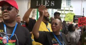 Hundreds of protestors marched to school district headquarters in Miami to protest curriculum standards that suggest enslaved people benefitted from slavery. (Credit: Screenshot - CBS Miami/YouTube)