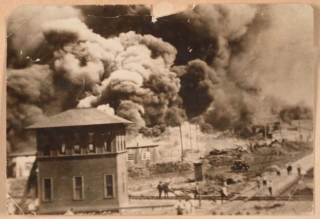 "Photograph of the Greenwood District burning during the Tulsa Race Massacre" by Unidentified is marked with CC0 1.0.