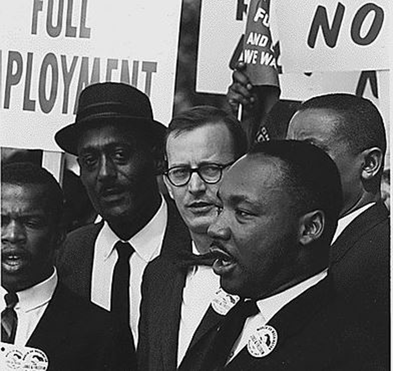 "Public Domain: Dr. Martin Luther King, Jr. at 1963 March on Washington by USIA (NARA)" by pingnews.com is marked with Public Domain Mark 1.0.