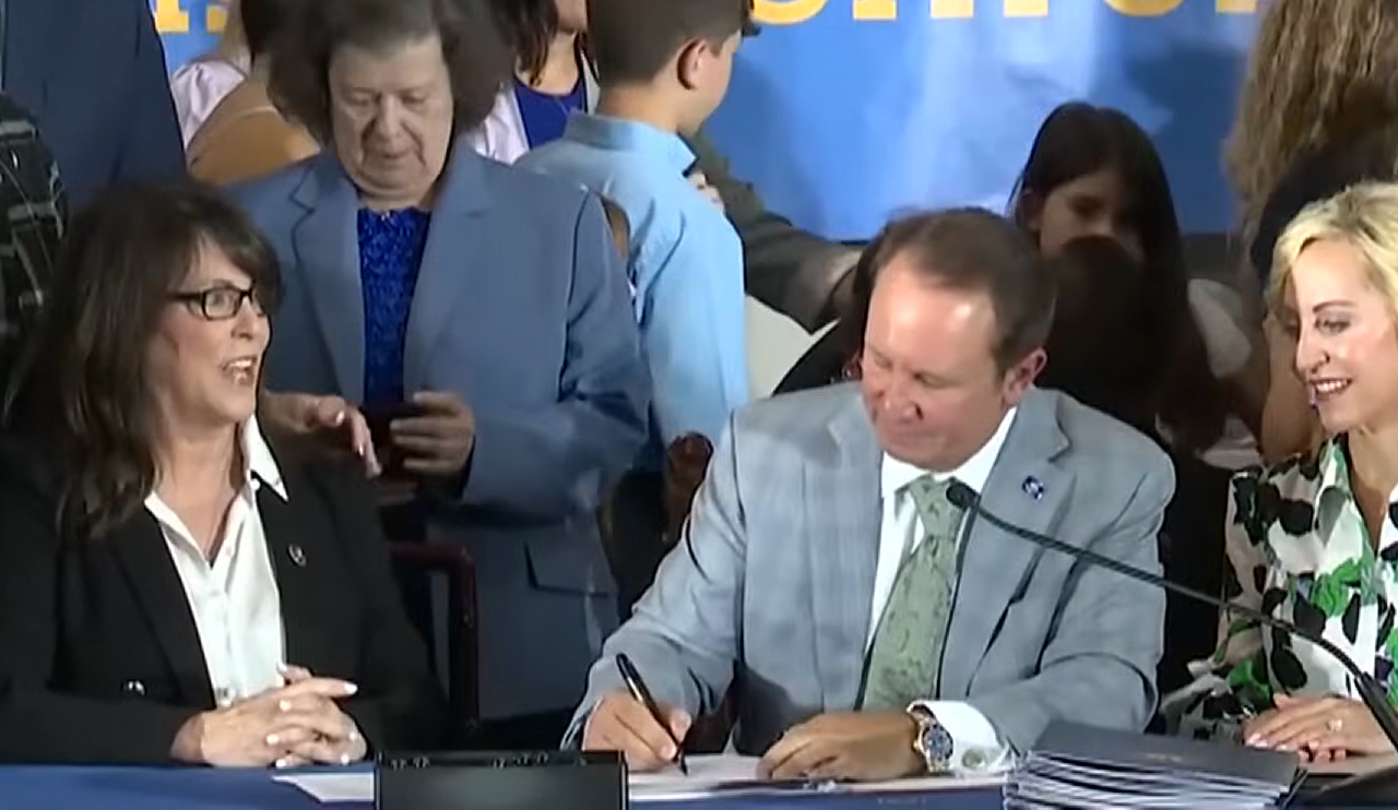 Louisiana Gov. Jeff Landry signs a bill on June 20, 2024 that would require the 10 Commandments be displayed in K-12 schools. (Source: Screenshot - WQAD News 8)